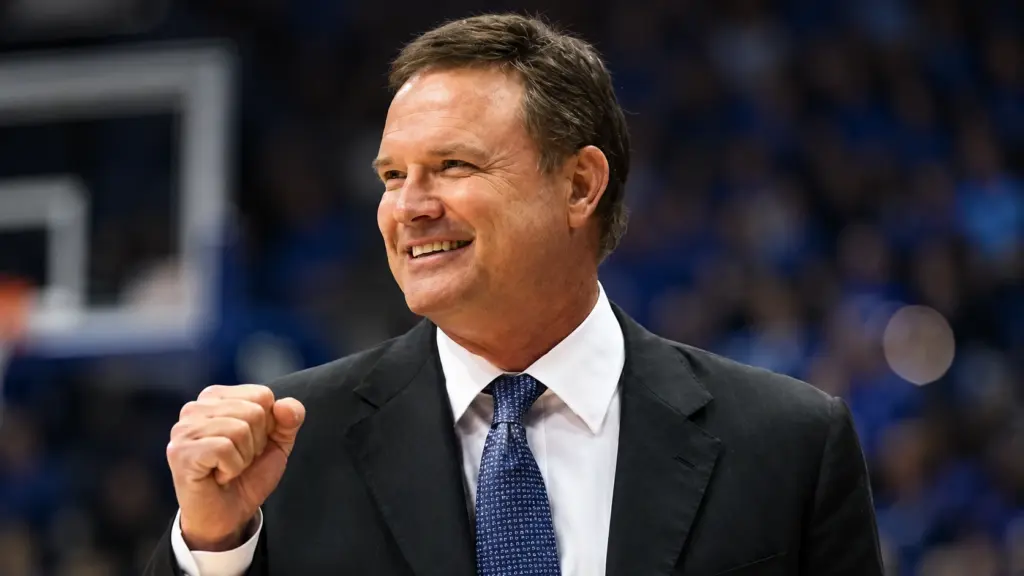 Bill Self standing in a basketball stadium, people are wondering: Does Bill Self wear a toupee?