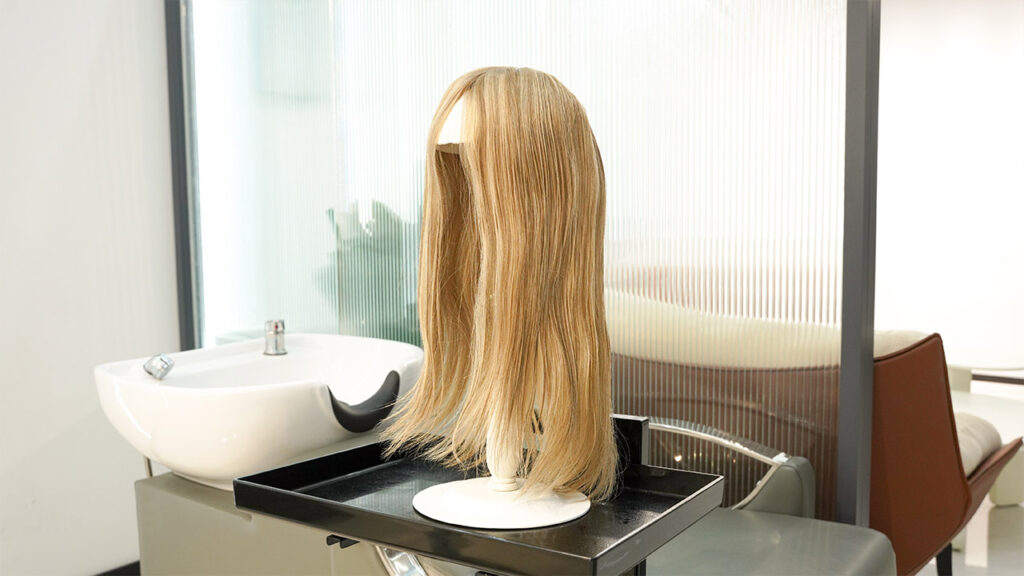 a human hair wig on a wig stand - demonstrating air drying human hair wigs benefits