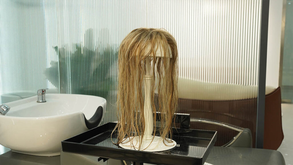 a human hair wig on a wig stand