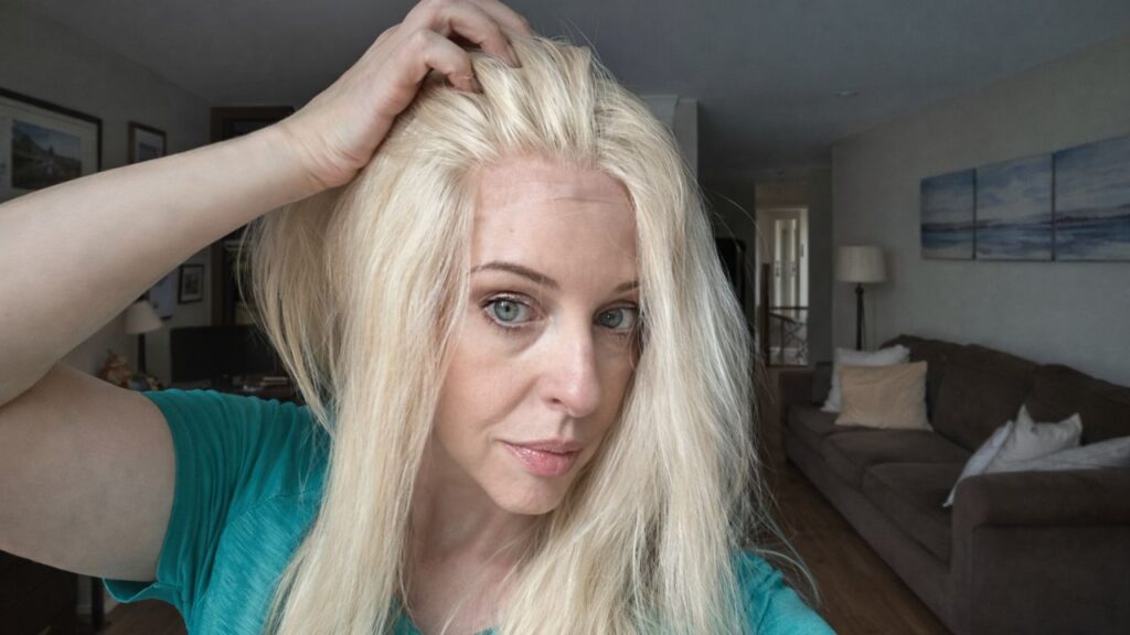 Woman wearing a blonde wig showing how to protect your hair under a wig
