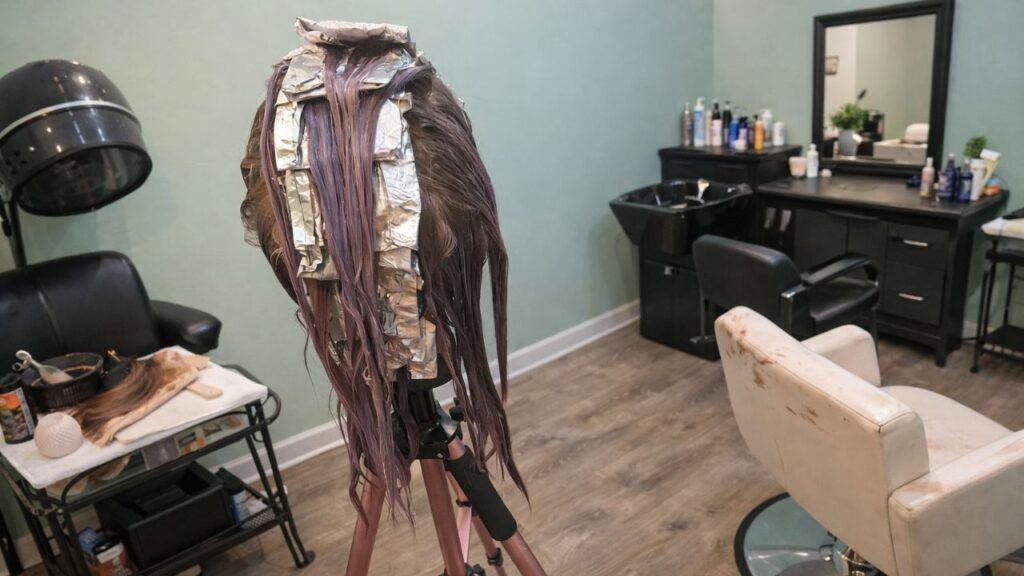 Human hair wig being dyed in a room demonstrating how to dye a human hair wig