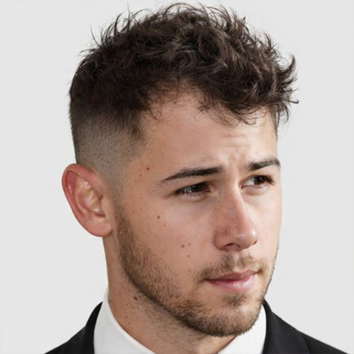 a man with short messey quiff