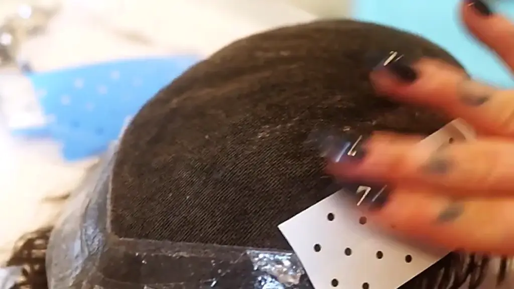 Applying both tape and glue to a hair system to improve summer bonding