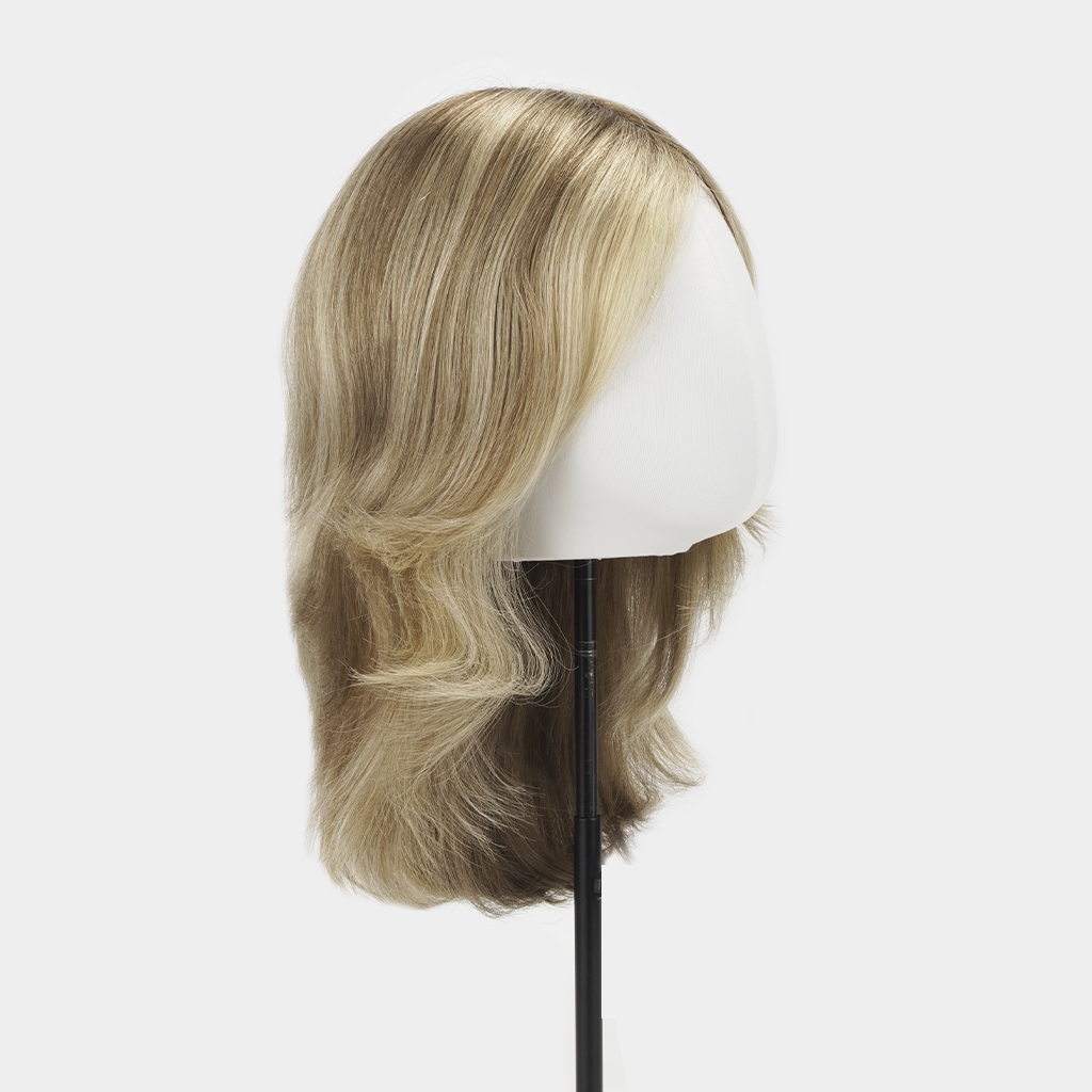 VALENNE longer-length European human hair wig with soft blonde balayage and layered ends, displayed on a mannequin stand.