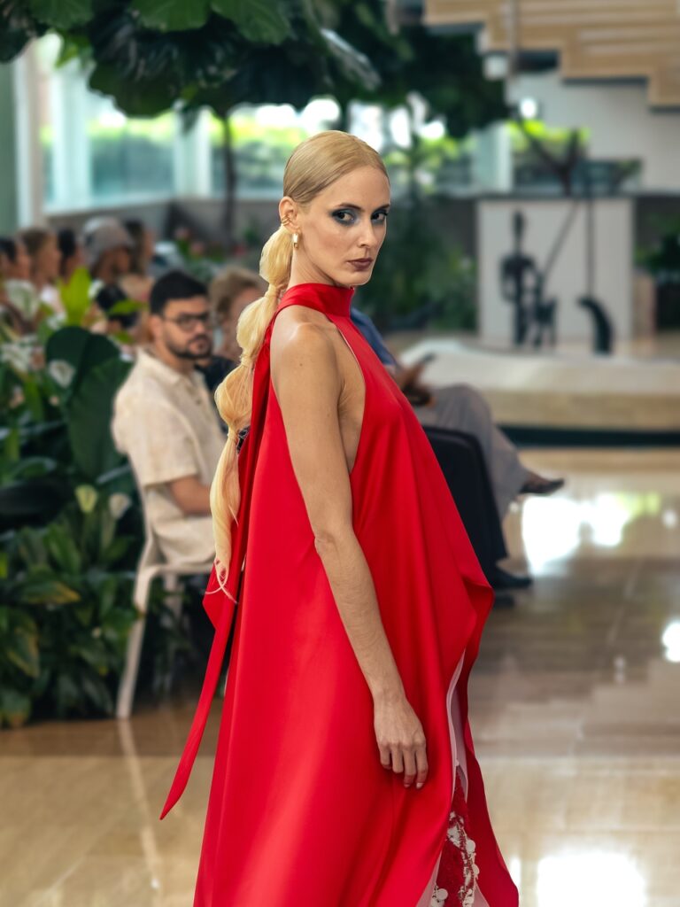 Blonde runway model in a red dress with a long bubble ponytail hairstyle at L’Espace Puerto Rico 2026.